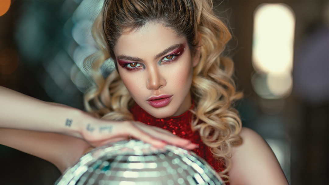 woman model holds disco ball