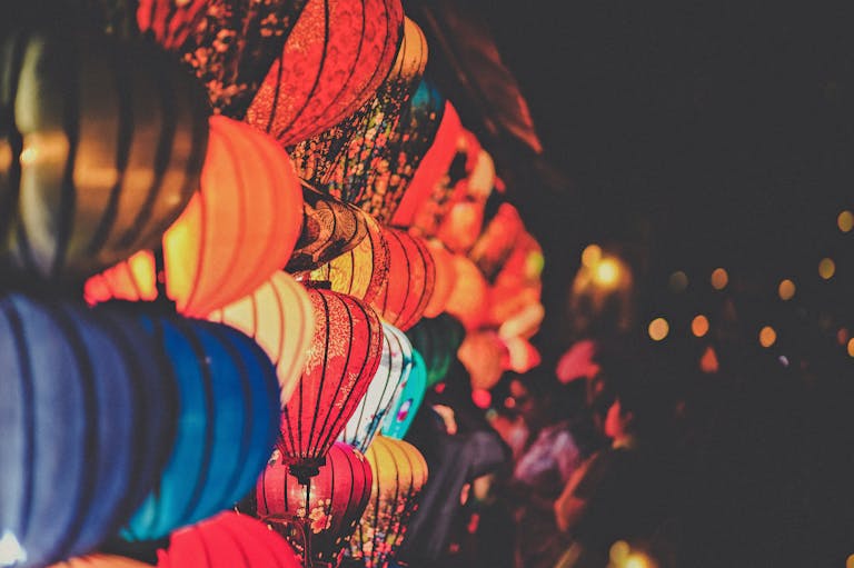 Vibrant multicolored lanterns illuminate the night, creating a festive and atmospheric scene.